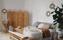 brown wooden door near brown woven armchair
